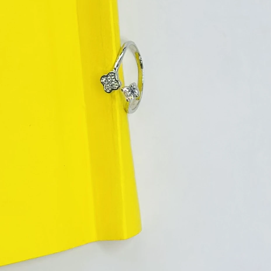 Silver bypass ring featuring lab-grown diamond floral clusters.