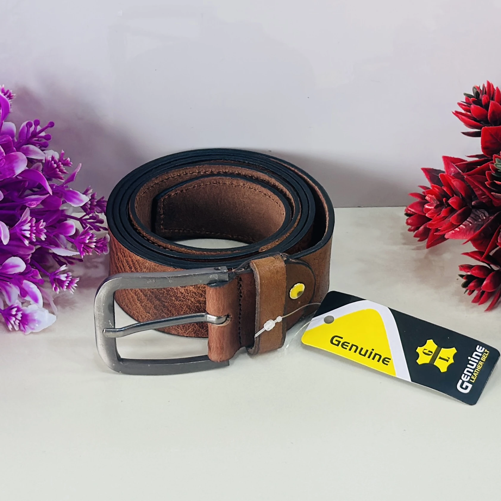 brown genuine leather belt with a pin buckle closure.