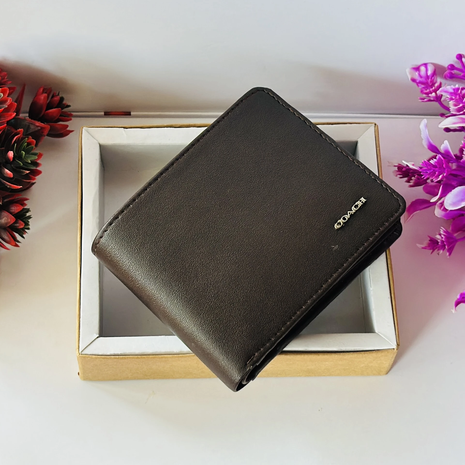 Brown Coach bifold wallet.