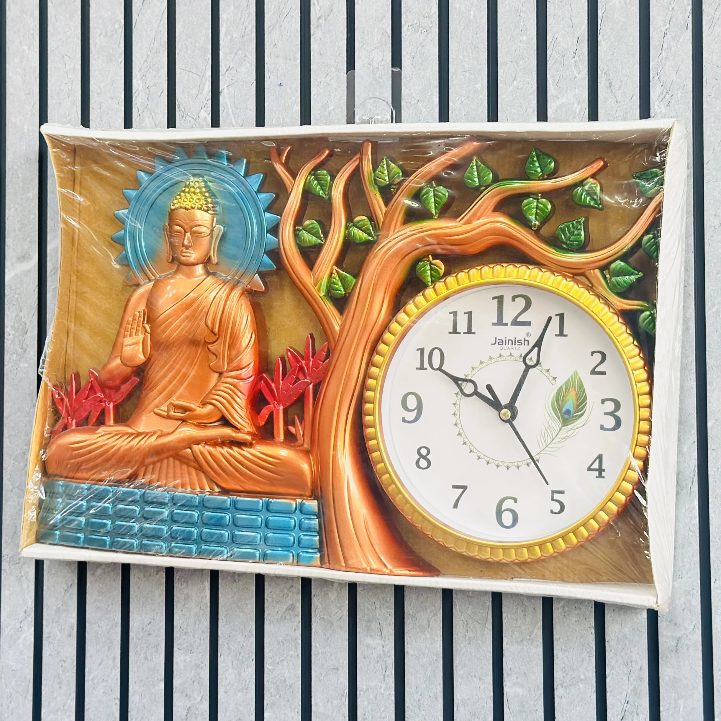 Wall clock featuring a depiction of Buddha under a tree.