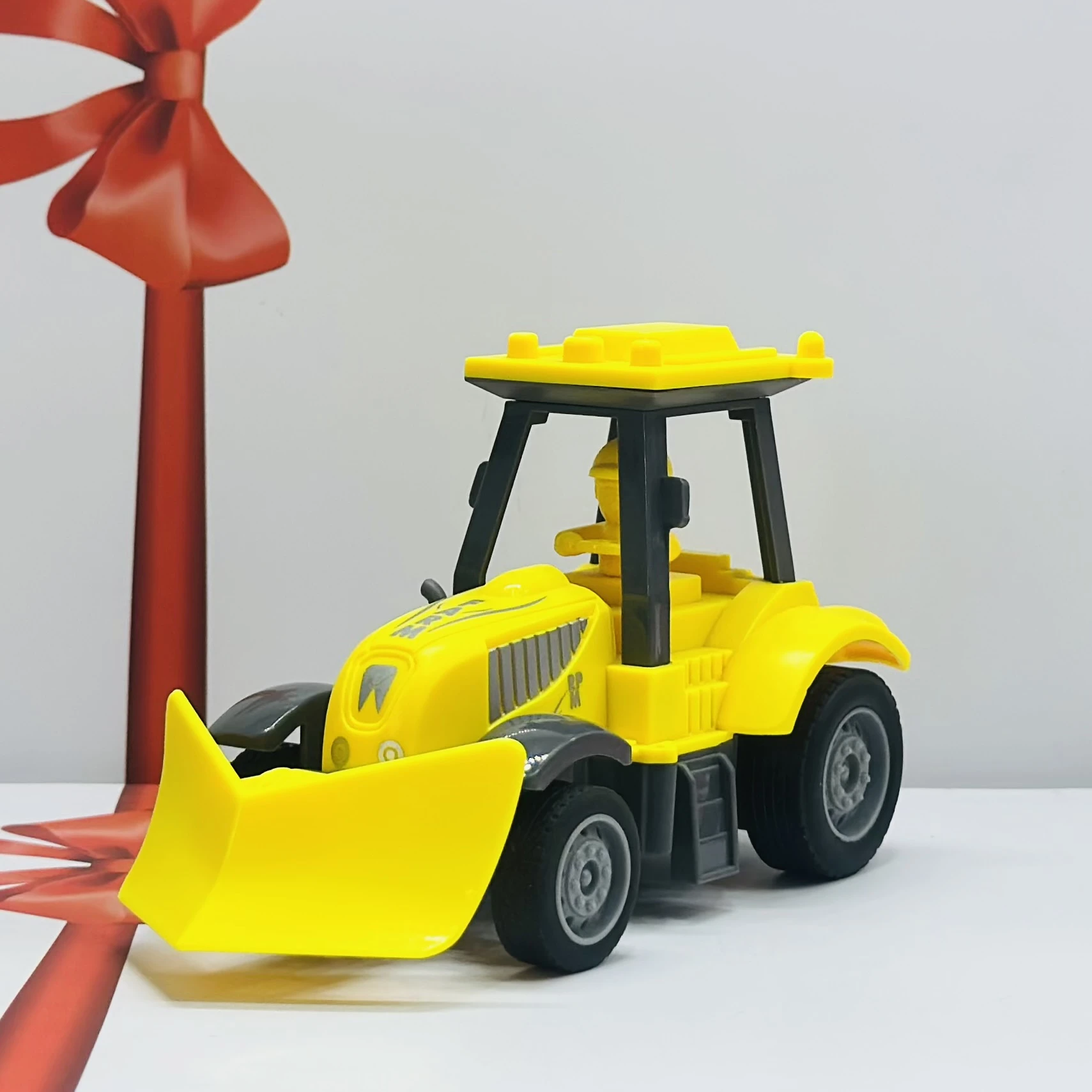 Yellow plastic toy tractor